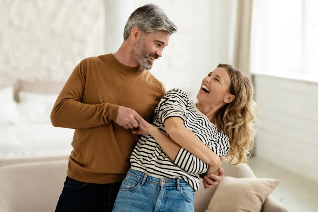 Couple laughing and holding each other